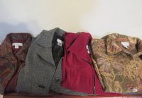 Four jackets side by side on surface