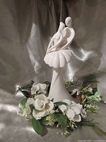 Front view of white porcelain dancing couple sculpture