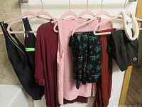 All seven garments on hangers showing overall lot