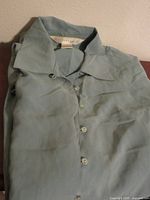 Folded light blue silk shirt