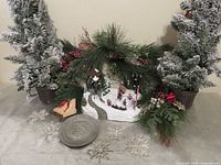 lot overview showing two flocked trees, pewter plate, village scene, snowflake ornaments
