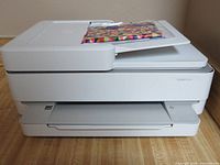 Front view of HP Envy 6455e printer showing output tray and scanner lid
