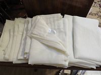 Folded cool white sheer panels displayed on surface