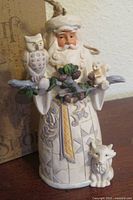 Front view of Santa ornament with owl, squirrel, fox detailing