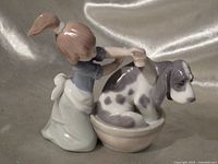 Front left view of figurine showing girl and dog in tub