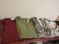 Four tops laid out showing colors and patterns