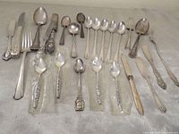 Full assortment of mixed silver flatware laid out