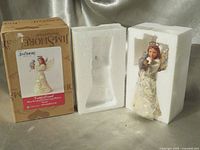 Figurine in Styrofoam next to original box