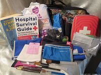 Lot overview showing both books, cooling towels, emergency tote, floral tote and accessories