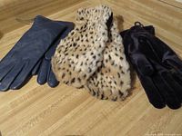 All three pairs: navy leather gloves, cheetah-print mittens, black velvet gloves