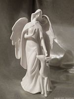 Front view of matte white winged angel figurine with fawn