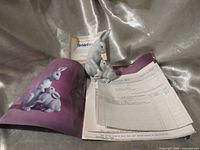 Figurine with certificate and paperwork displayed