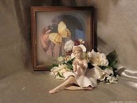 Full view of ballerina figurine, shadow box with butterfly, and floral arrangement