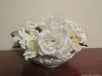 Bowl shown with artificial white flowers inside