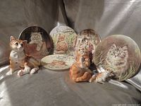 Group shot of five plates and three figurines