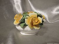 Front view of porcelain bouquet showing roses and oval bowl base