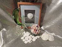 Group shot of dolphin sculpture, framed sand dollar print, shell floral, and sand dollars