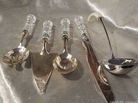 Full view of four crystal-handled utensils