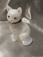 Front view of opalescent glass cat figurine with rhinestone collar