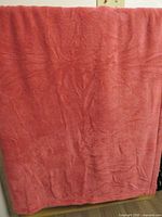Pink plush blanket draped to show full size and texture