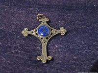 Front view of sterling silver cross pendant with lapis lazuli center