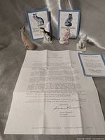 Group shot of four figurines with paperwork