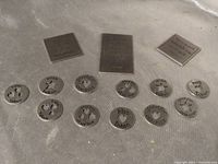 overview of metal plaques and sentiment tokens