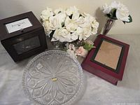 Group shot of all five items: crystal plate, photo organizer box, photo album, silver vase, rose accent