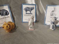 Front view of three cat figurines with booklets