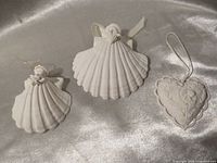 Two shell angel ornaments and one heart ornament, front view