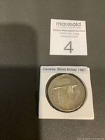 Coin reverse displaying flying goose and date in 2x2 holder