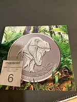 Front of boxed coin showing Tyrannosaurus Rex design and 2016 date