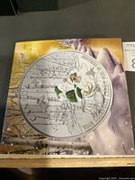 Illustrated outer packaging showing coin artwork