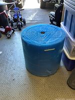 Full roll of blue bubble wrap standing upright