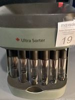 Front view showing Ultra Sorter branding, maple leaf icon and coin tubes