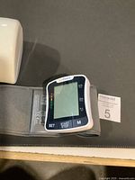 Monitor with cuff and partial view of storage case