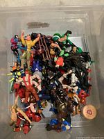 Top view of bin with mixed action figures