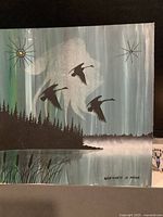 Full view of painting showing geese, spirit figure, trees, water, signature