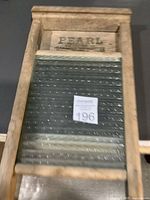 Full view of antique washboard showing wood frame and glass panel