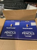 Open shipping carton showing multiple Pencil Buddies boxes