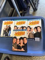 All four Seinfeld DVD box sets displayed on bin