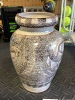 Full view of signed Enrique studio pottery vase showing speckled glaze and shape