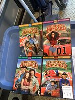 Front view of four DVD season box sets showing cover art and season numbers