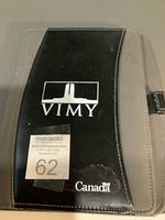 Front view of black and gray VIMY Canada zip-around portfolio showing logo and exterior wear