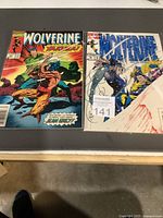 Front covers of both Wolverine comics #32 and #78 in bags