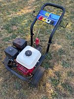 Full view of BE pressure washer showing frame, wheels, engine and handle