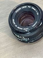 Front oblique view showing Canon branding, 50mm f/1.8 marking, rim wear