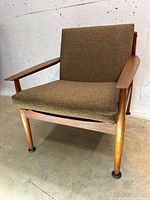 Front view of armchair showing upholstery and frame