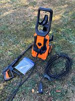 Full view of pressure washer, spray gun, manual, power cord