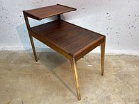 Front angle view showing two-tier design and legs